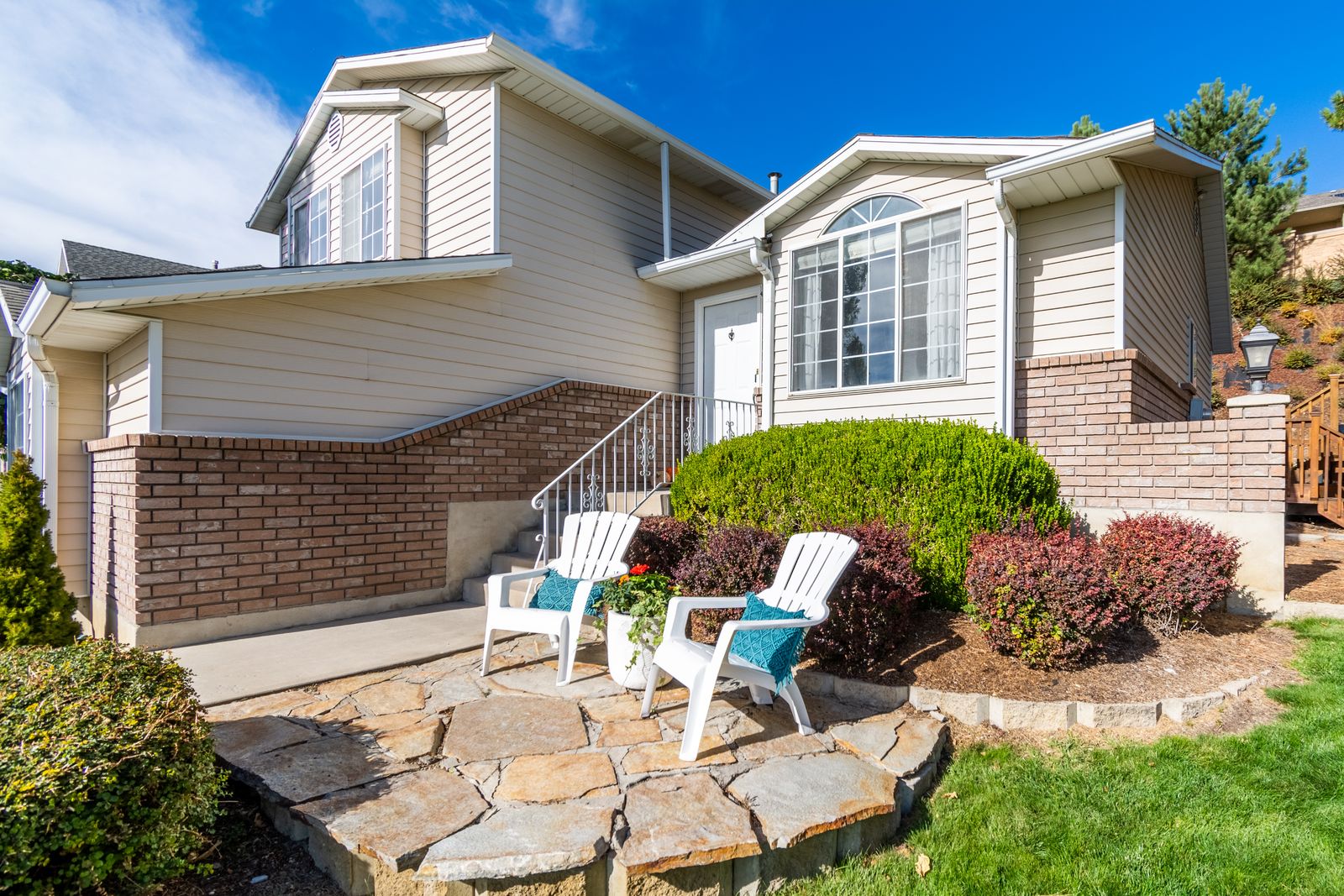 Well-kept suburban home with landscaped gardens and a green lawn
